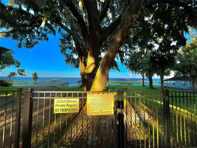 a view of an outdoor space and deck with a lake view