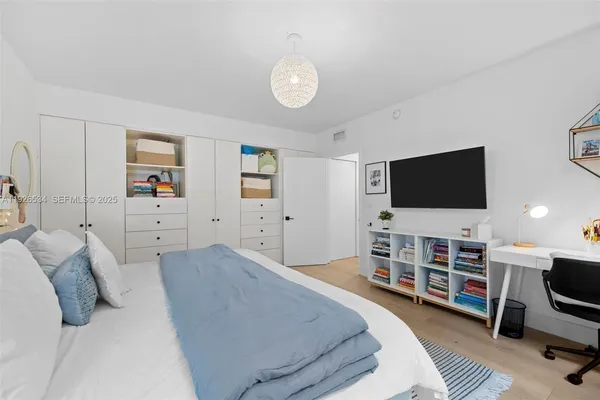a bedroom with furniture and a flat screen tv