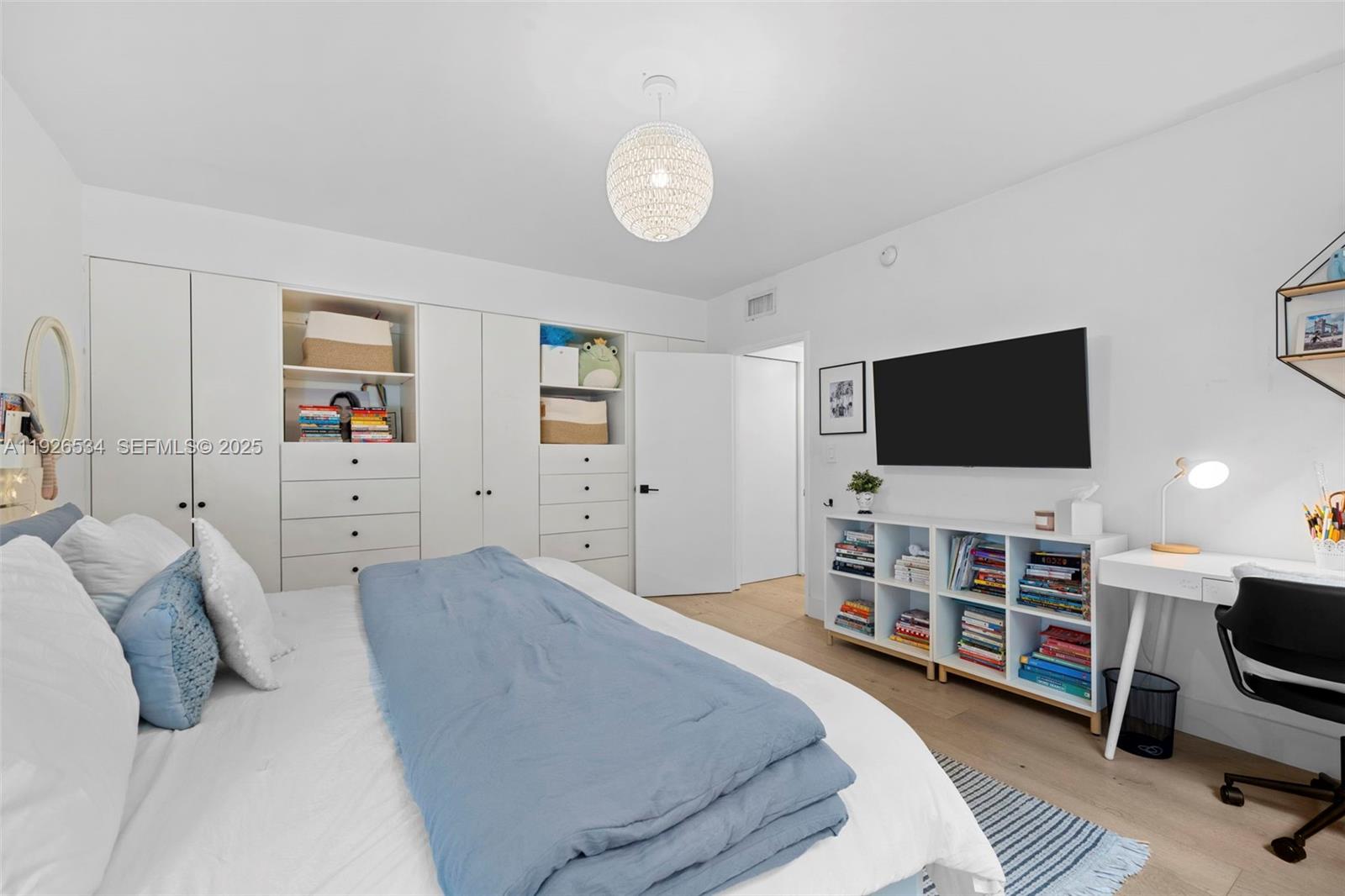 141 Crandon Boulevard, Unit 237 Key Biscayne, FL 33149 - Photo 11 of 38 a bedroom with furniture and a flat screen tv