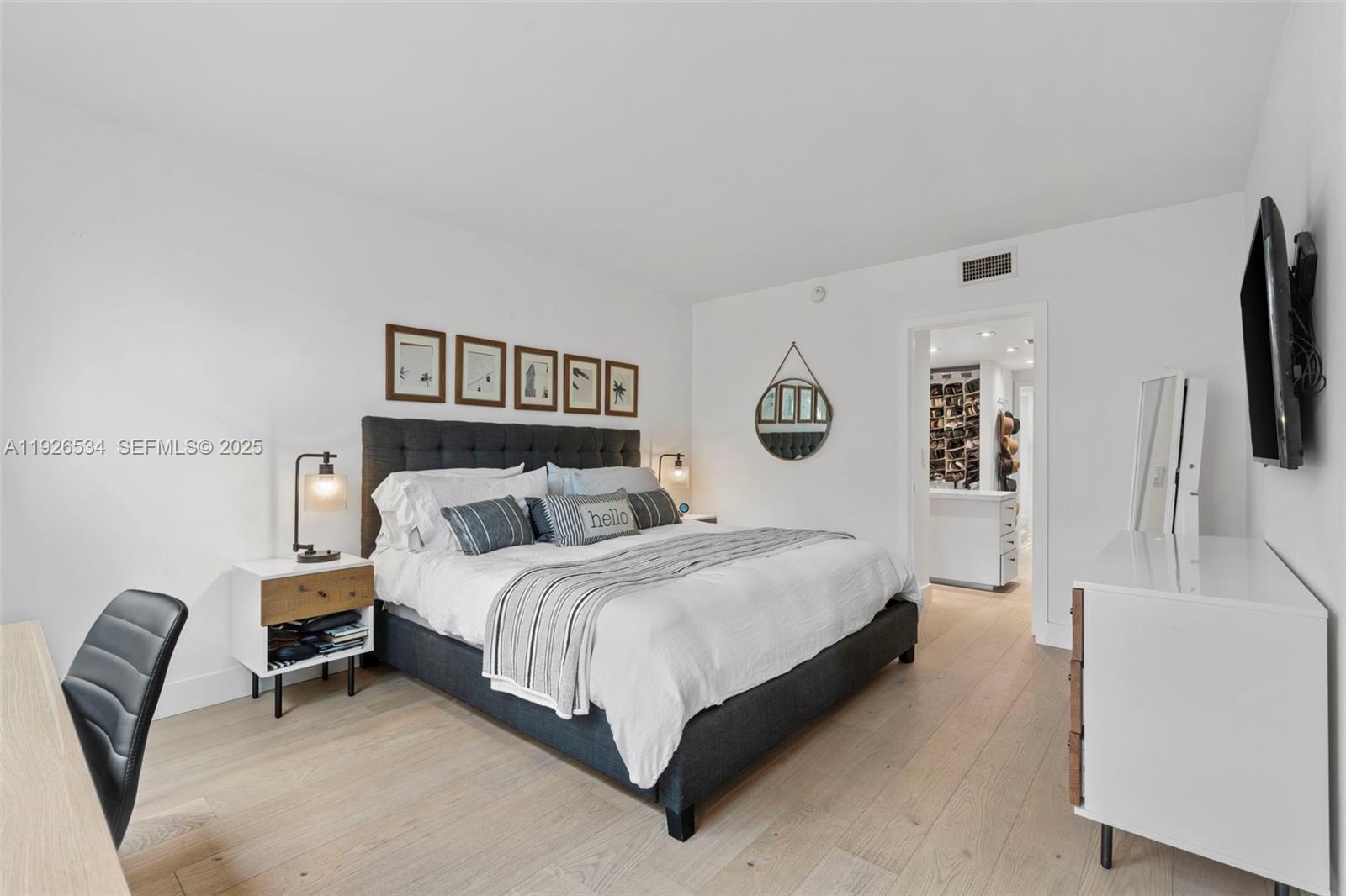 141 Crandon Boulevard, Unit 237 Key Biscayne, FL 33149 - Photo 13 of 38 a bedroom with a bed a couch and a flat tv screen on the dresser