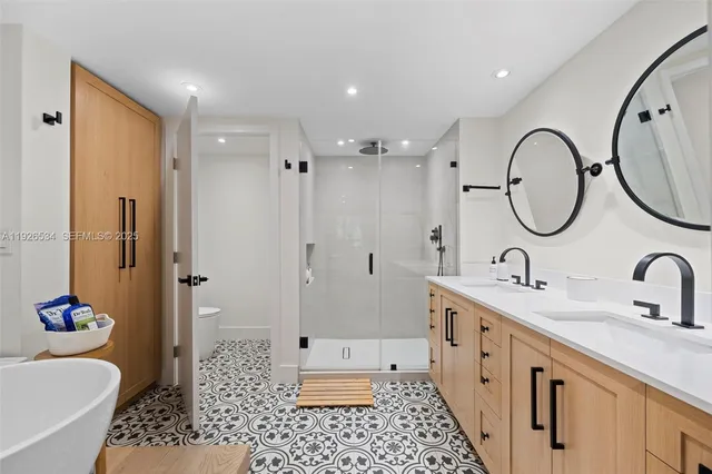 a bathroom with a double vanity sink mirror and shower