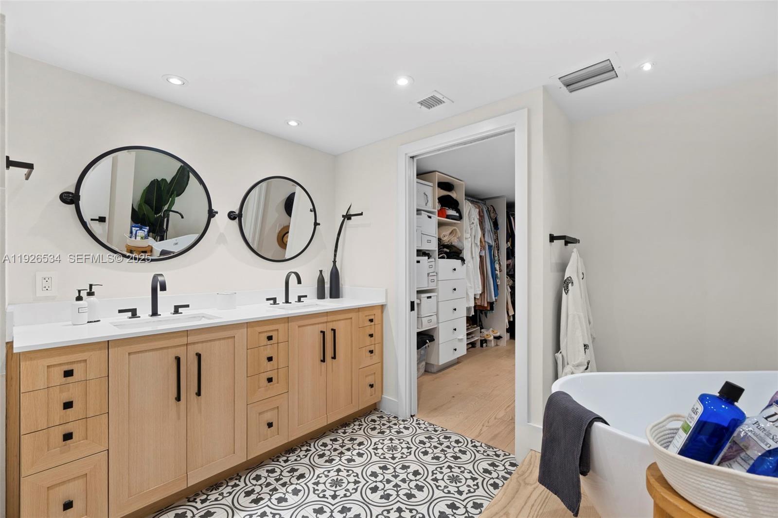 141 Crandon Boulevard, Unit 237 Key Biscayne, FL 33149 - Photo 18 of 38 a bathroom with a double vanity sink a toilet and a mirror