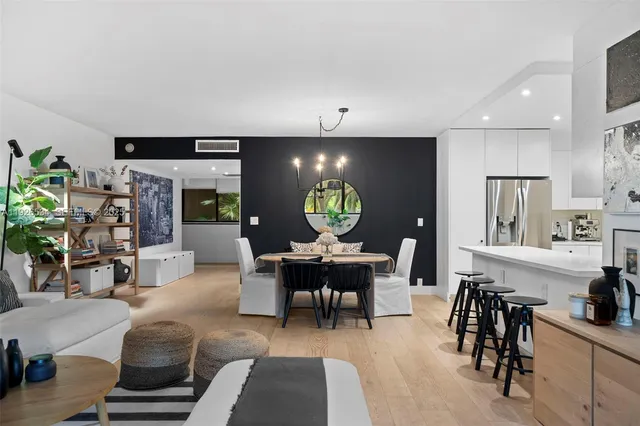a living room with furniture a dining table and chairs with kitchen view