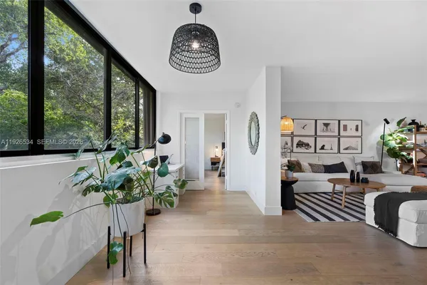 a view of living room filled with furniture and a potted plant