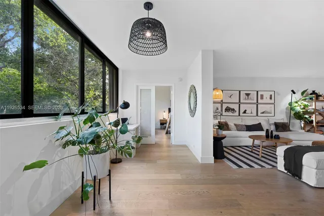 a view of living room filled with furniture and a potted plant