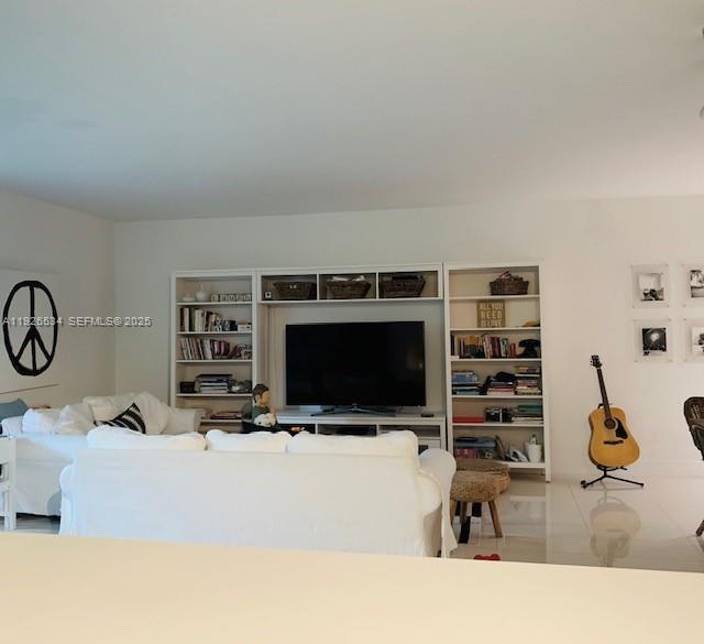 141 Crandon Boulevard, Unit 237 Key Biscayne, FL 33149 - Photo 28 of 38 a living room with furniture and a flat screen tv