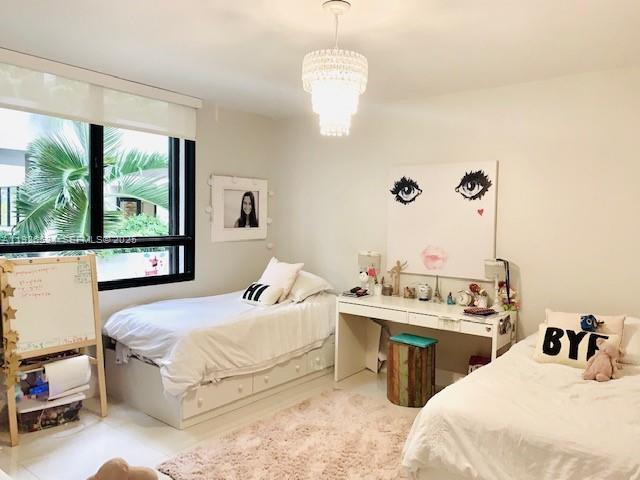 141 Crandon Boulevard, Unit 237 Key Biscayne, FL 33149 - Photo 29 of 38 a bedroom with a bed and a large window