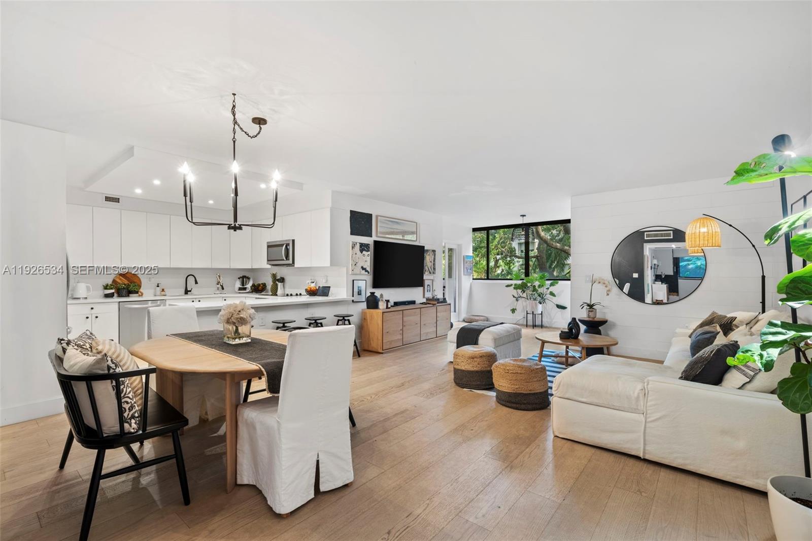 141 Crandon Boulevard, Unit 237 Key Biscayne, FL 33149 - Photo 3 of 38 a living room with furniture and a flat screen tv