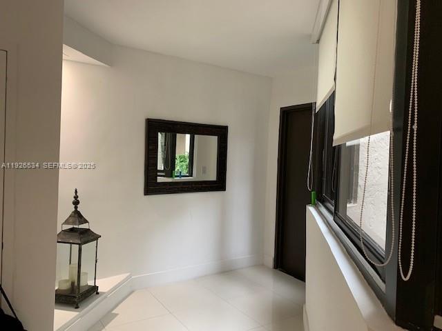 141 Crandon Boulevard, Unit 237 Key Biscayne, FL 33149 - Photo 33 of 38 a view of a hallway with washer and dryer