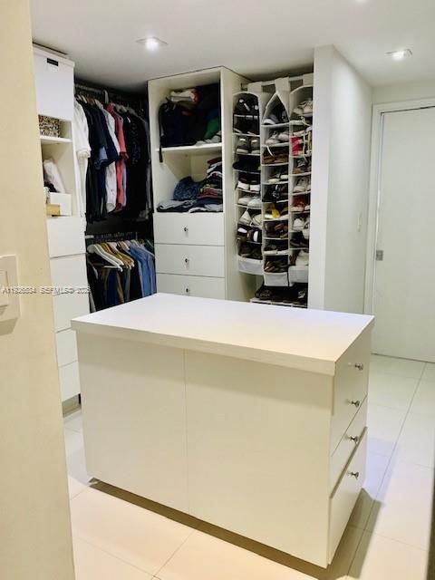 141 Crandon Boulevard, Unit 237 Key Biscayne, FL 33149 - Photo 34 of 38 a view of walk in closet with clothes and shoes