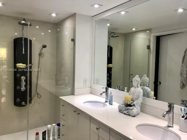 a bathroom with a sink double vanity and shower