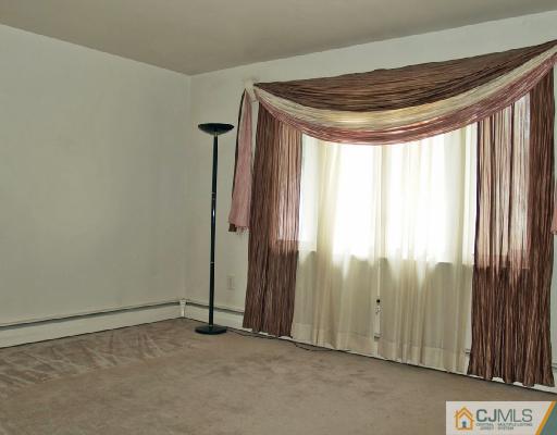 71 Middle Hill Road Colonia, NJ 07067 - Photo 2 of 10 an empty room with windows