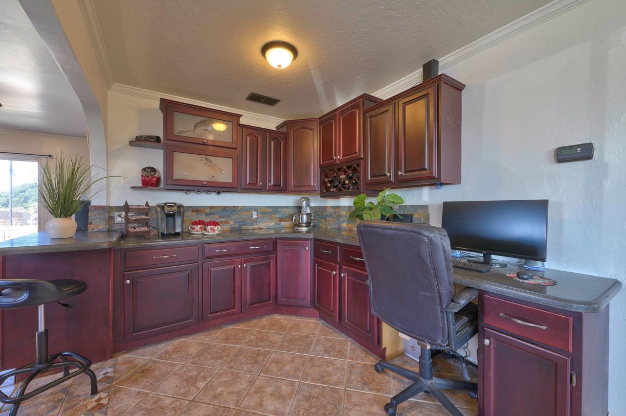 14485 Russo Road Castroville, CA 95012 - Photo 12 of 55 a kitchen with granite countertop a stove a sink dishwasher a dining table and chair with wooden floor