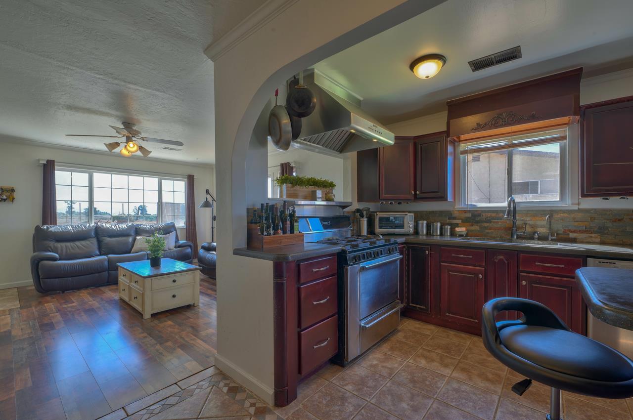 14485 Russo Road Castroville, CA 95012 - Photo 14 of 55 a kitchen with stainless steel appliances granite countertop a sink dishwasher stove and cabinets