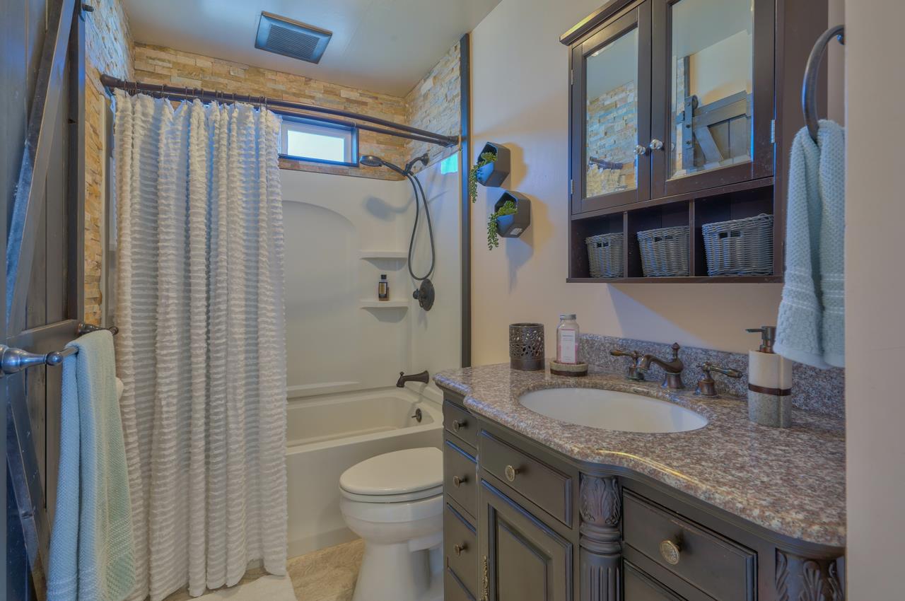 14485 Russo Road Castroville, CA 95012 - Photo 21 of 55 a bathroom with a granite countertop sink toilet and shower