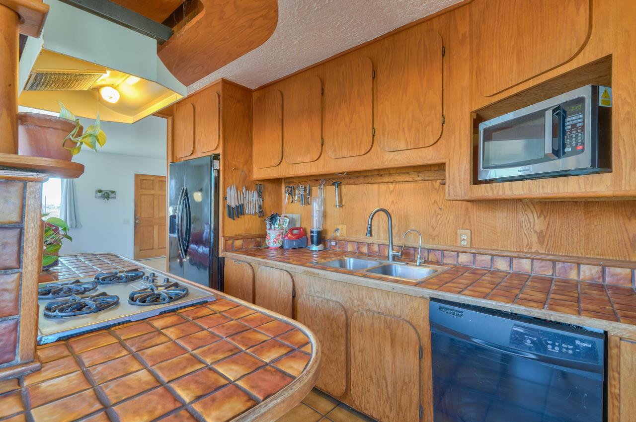 14485 Russo Road Castroville, CA 95012 - Photo 32 of 55 a kitchen with stainless steel appliances granite countertop a stove top oven a sink dishwasher and cabinets with wooden floor
