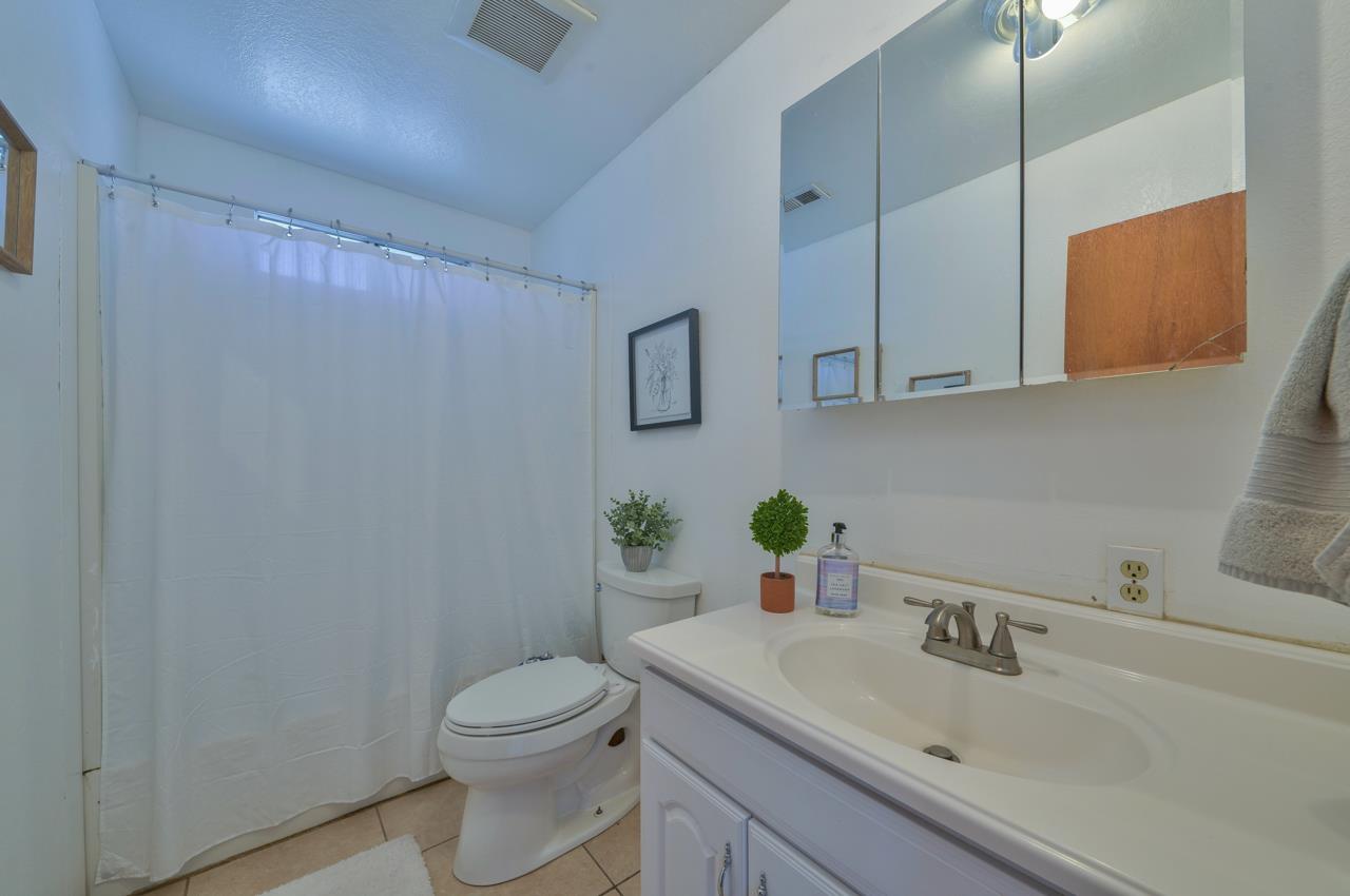 14485 Russo Road Castroville, CA 95012 - Photo 40 of 55 a bathroom with a sink a toilet and mirror