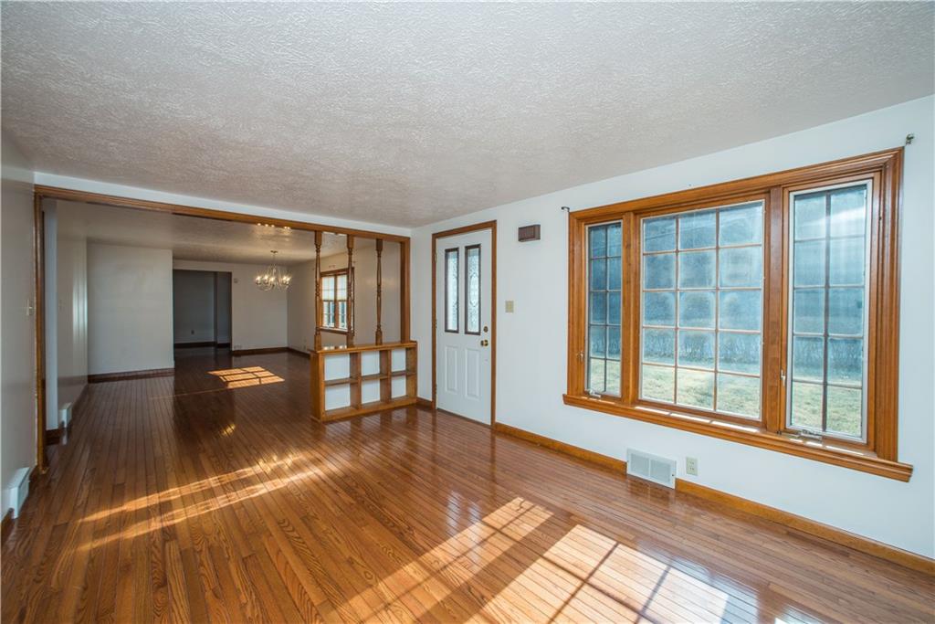 4138 Battle Ridge Road McDonald, PA 15057 - Photo 3 of 25 The 16x11 living room features a large picture window and beautiful hardwood floors.