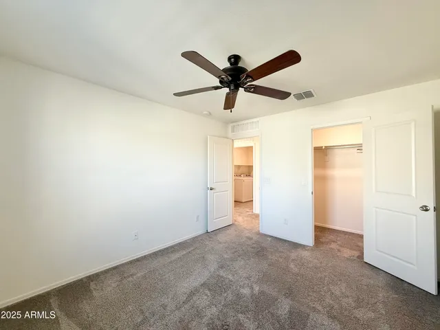 a view of a big room with a ceiling fan