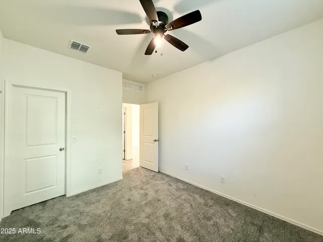 en empty room with ceiling fan