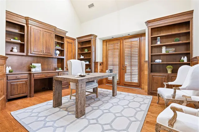 a work room with furniture a rug and wooden floor