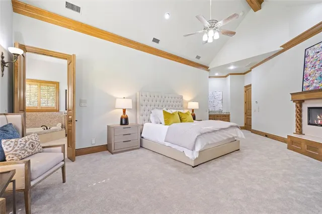 a spacious bedroom with a bed and a couch