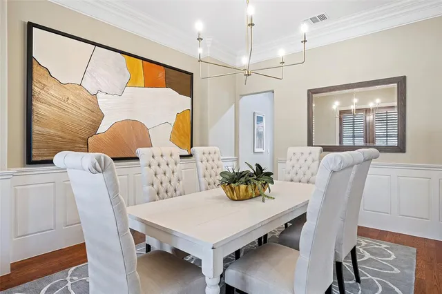 a view of a dining room with furniture and a chandelier