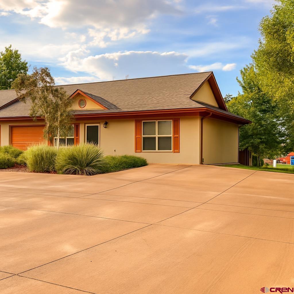 235 North Chestnut Street, Unit 6 Cortez, CO 81321 - Photo 1 of 17 a front view of a house with a garden