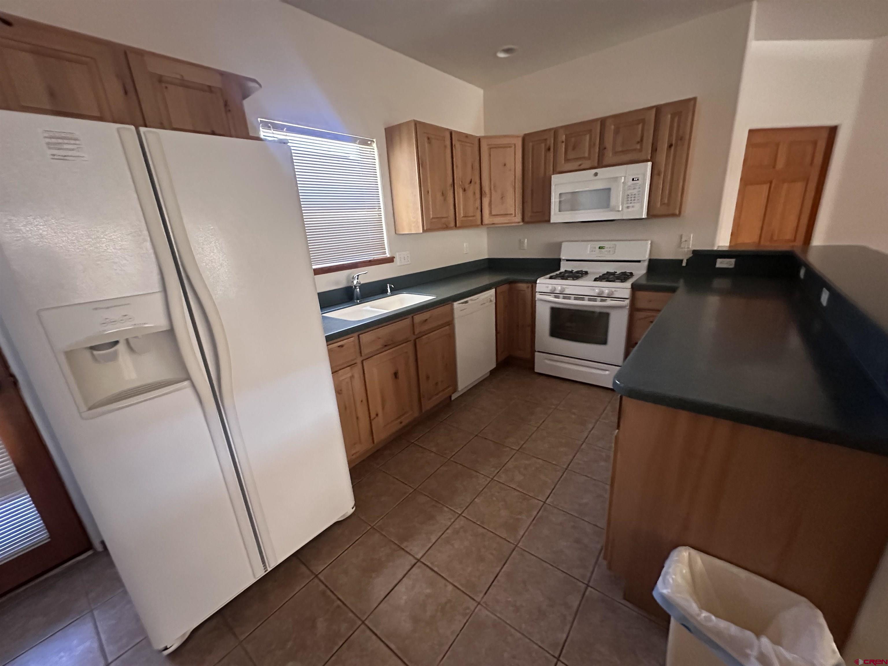 235 North Chestnut Street, Unit 6 Cortez, CO 81321 - Photo 4 of 17 a kitchen with stainless steel appliances a refrigerator a stove a sink and a counter