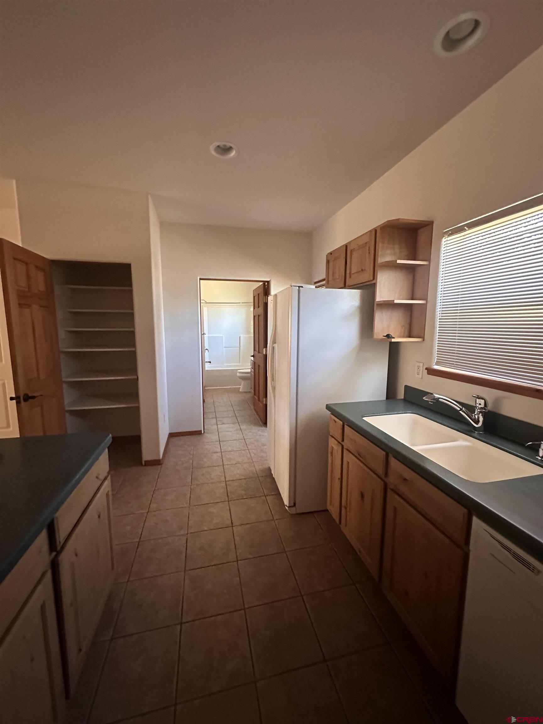 235 North Chestnut Street, Unit 6 Cortez, CO 81321 - Photo 5 of 17 a kitchen with stainless steel appliances a sink stove and refrigerator