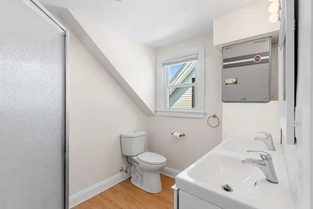a bathroom with a toilet sink and mirror