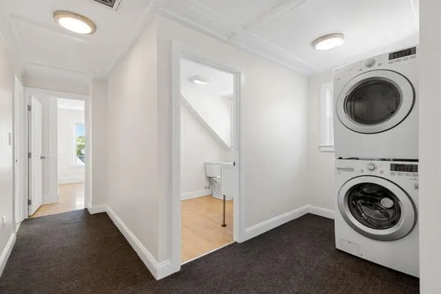 a utility room with sink dryer and washer