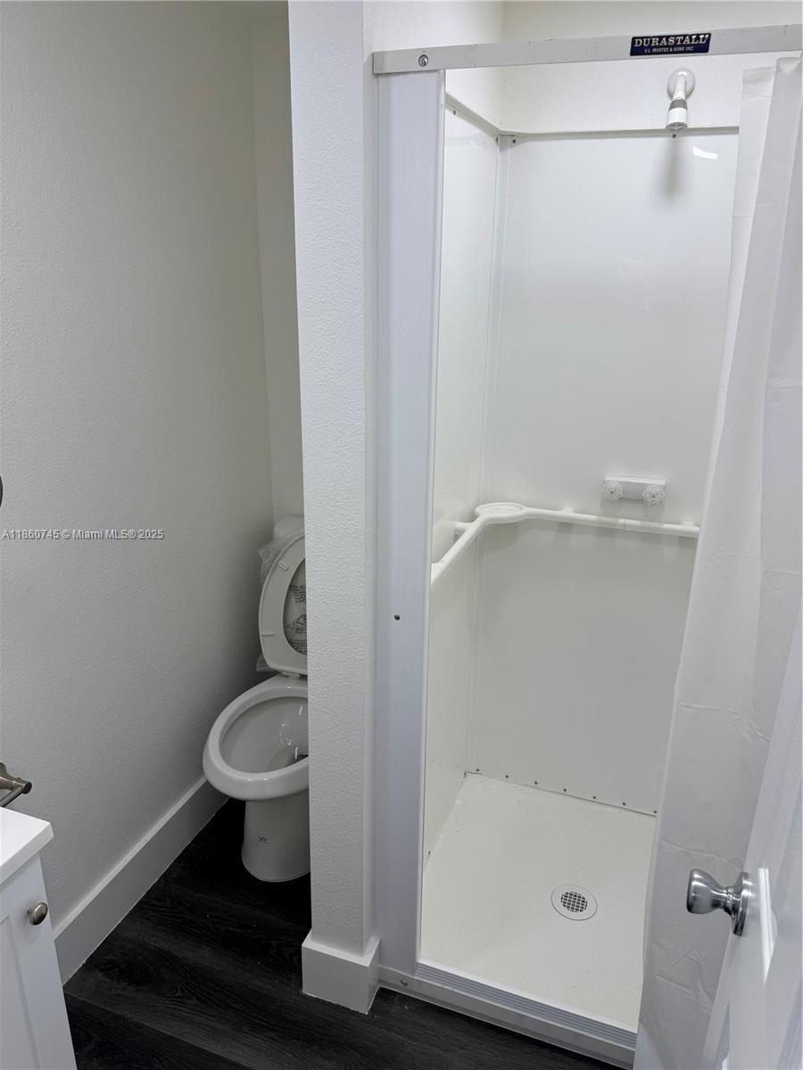 11751 Southwest 190th Terrace, Unit 1A Miami, FL 33177 - Photo 6 of 8 a bathroom with a shower and a toilet