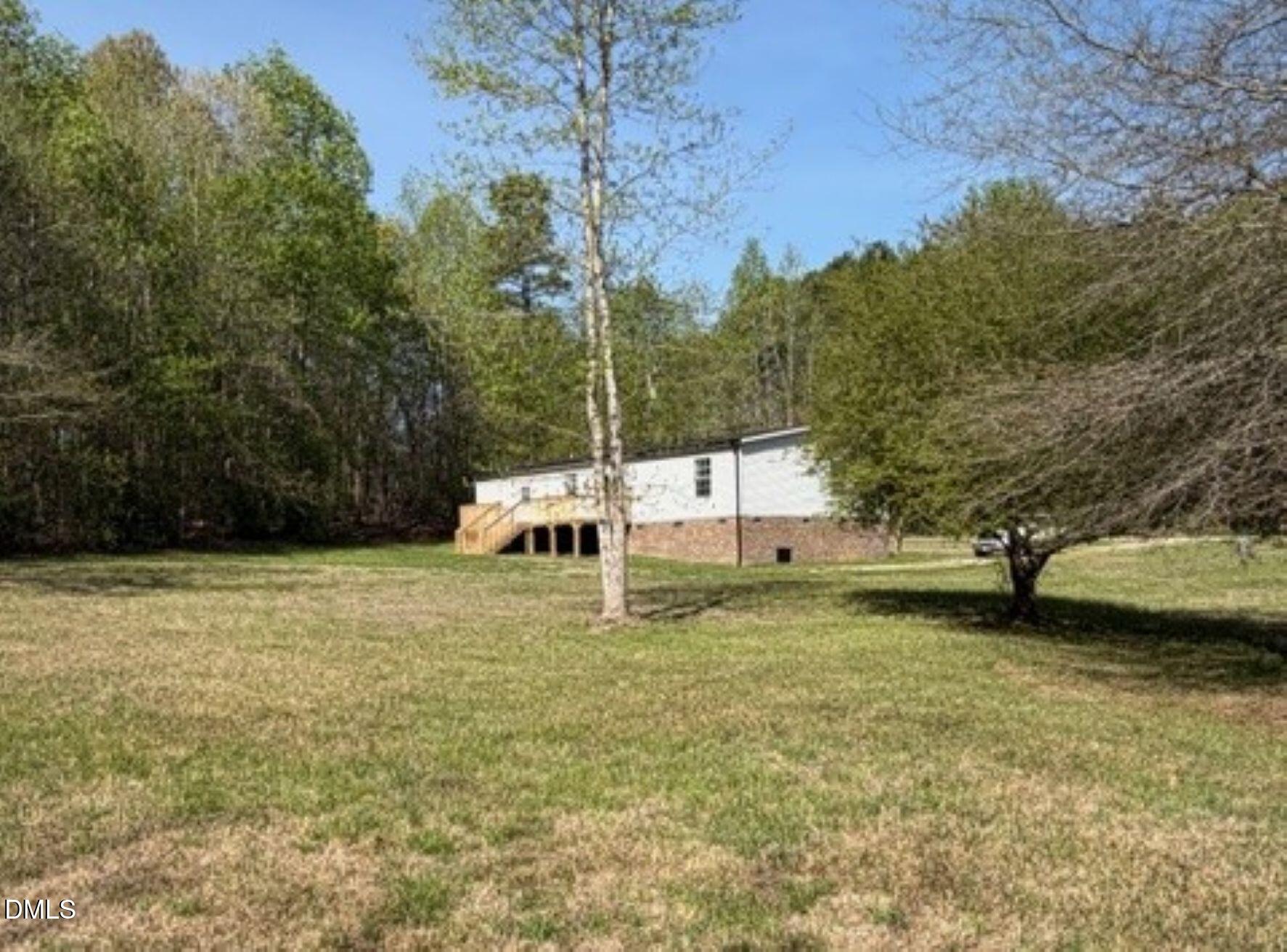 721 General Green Road Kittrell, NC 27544 - Photo 32 of 36 a backyard of a house with table and chairs