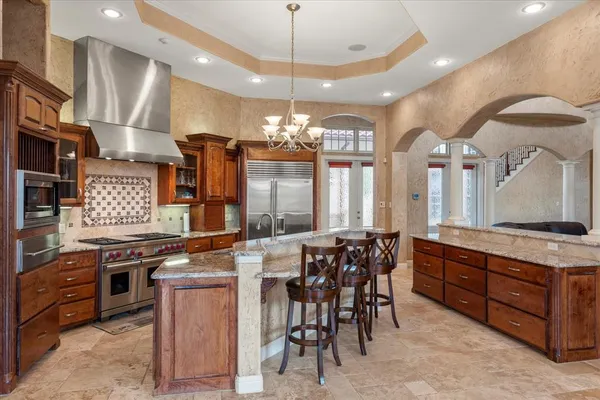 a dining table with chairs and chandelier