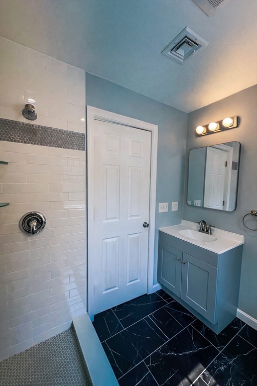 14 Hillside Road Northborough, MA 01532 - Photo 12 of 13 a bathroom with a sink a toilet a mirror and shower