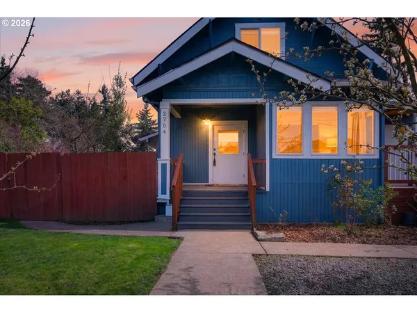 a view of house with backyard space and garden