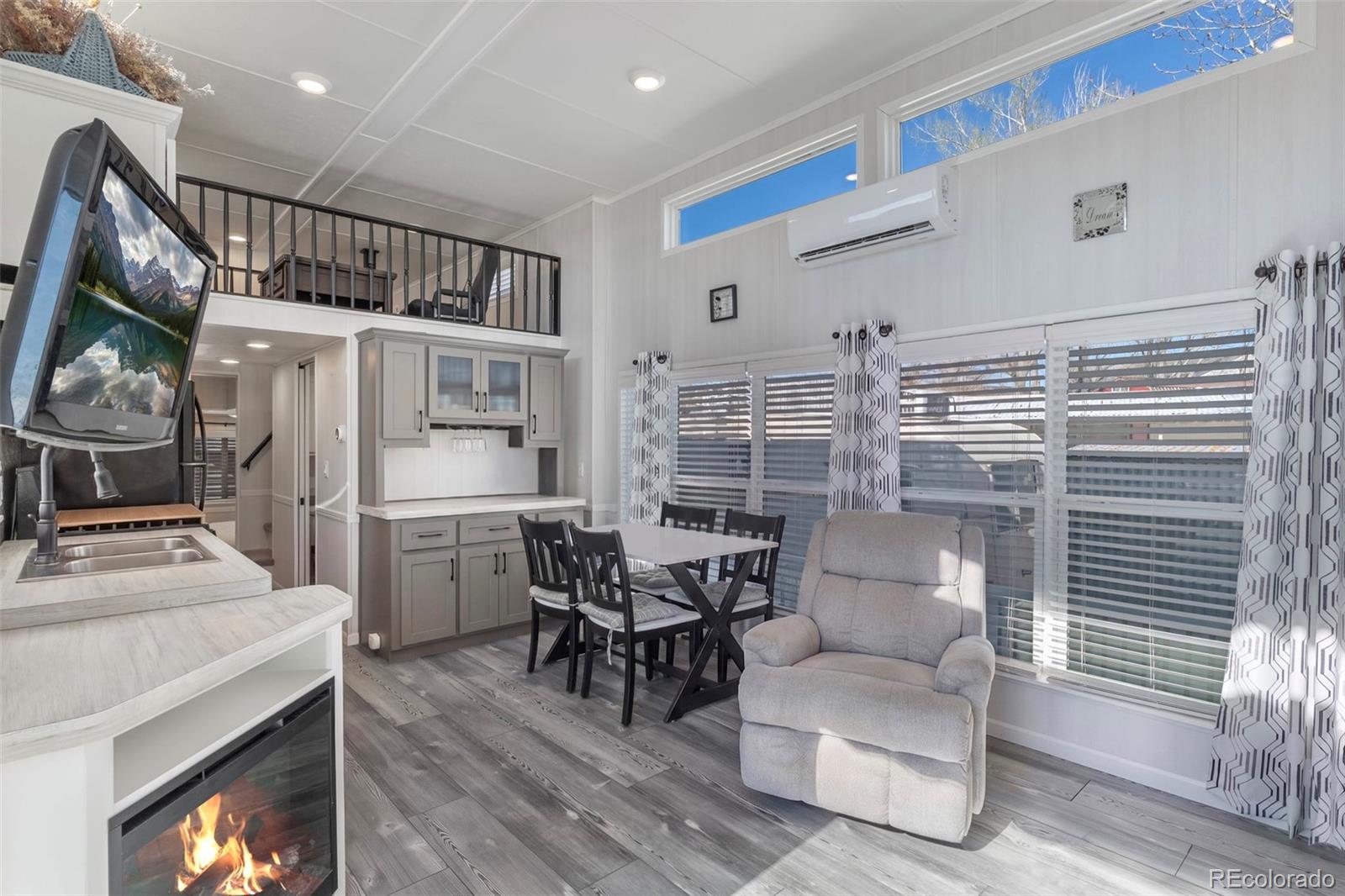 a livingroom with furniture wooden floor and a fireplace