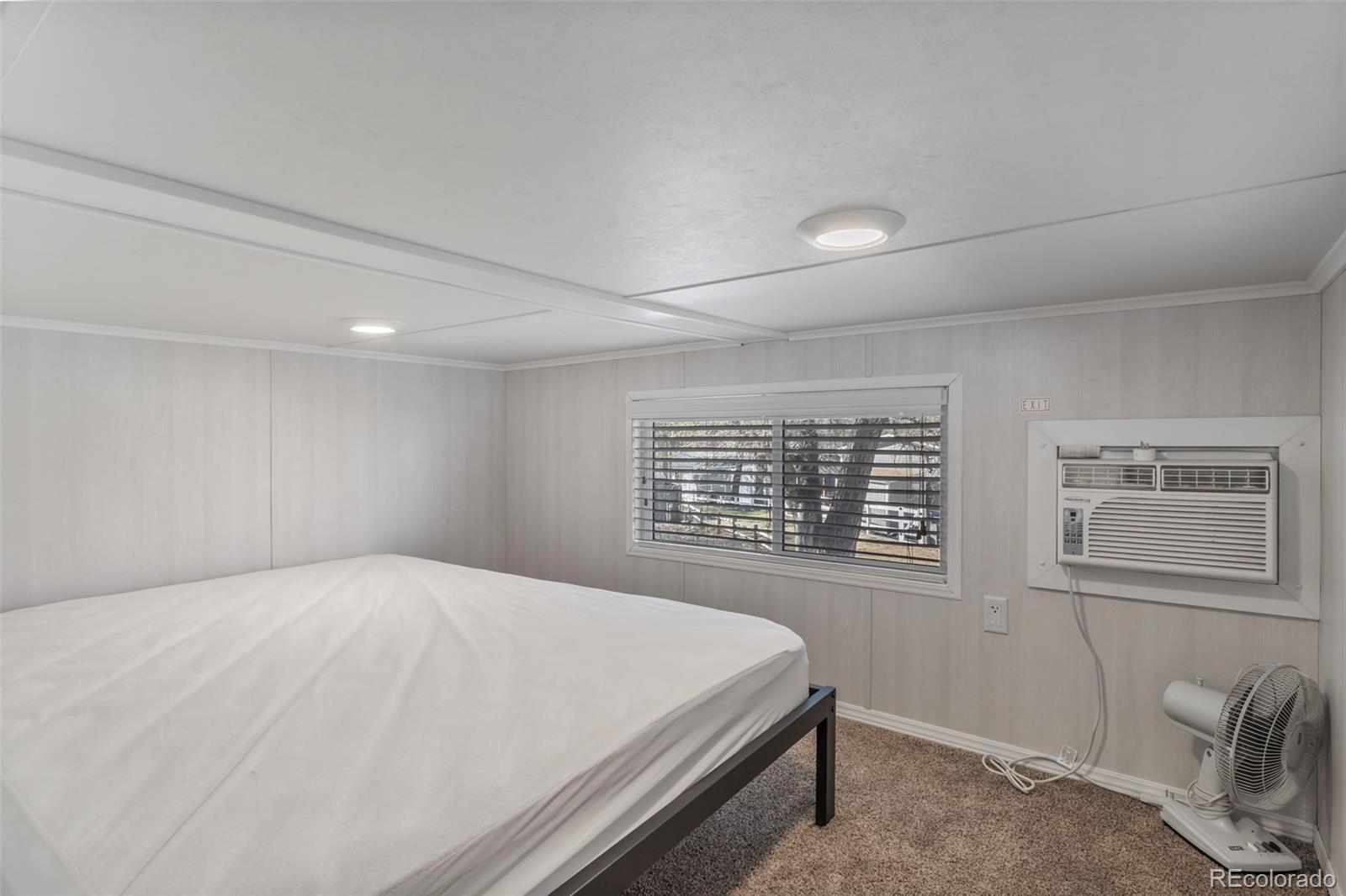 188 Kiowa Road Weldona, CO 80653 - Photo 11 of 34 a large bed sitting in a room next to a window