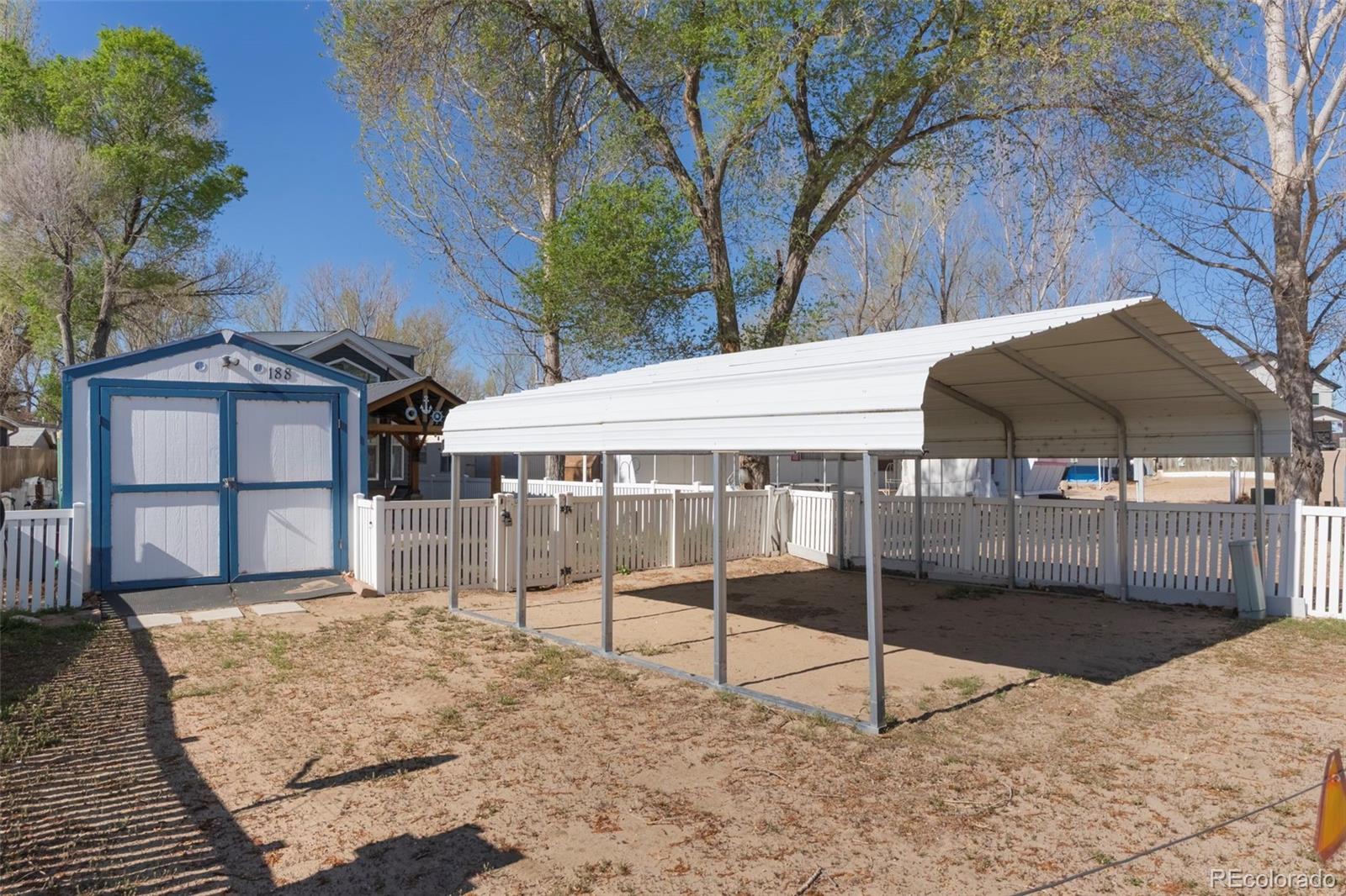 188 Kiowa Road Weldona, CO 80653 - Photo 13 of 34 a backyard of a house with table and chairs