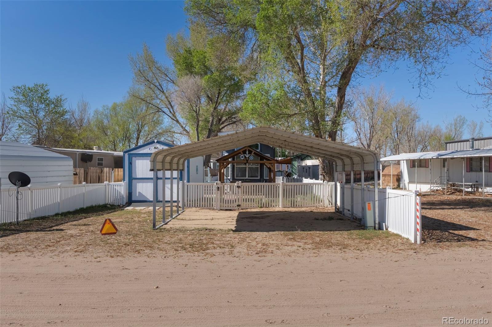 188 Kiowa Road Weldona, CO 80653 - Photo 15 of 34 a front view of a house with a yard