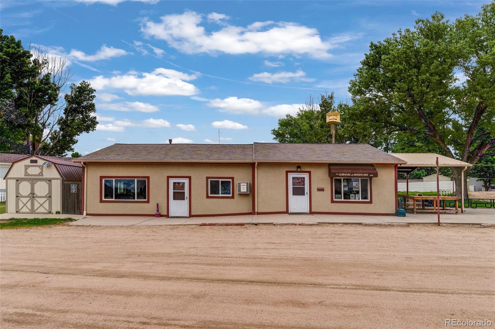 188 Kiowa Road Weldona, CO 80653 - Photo 22 of 34 a front view of a house with a yard