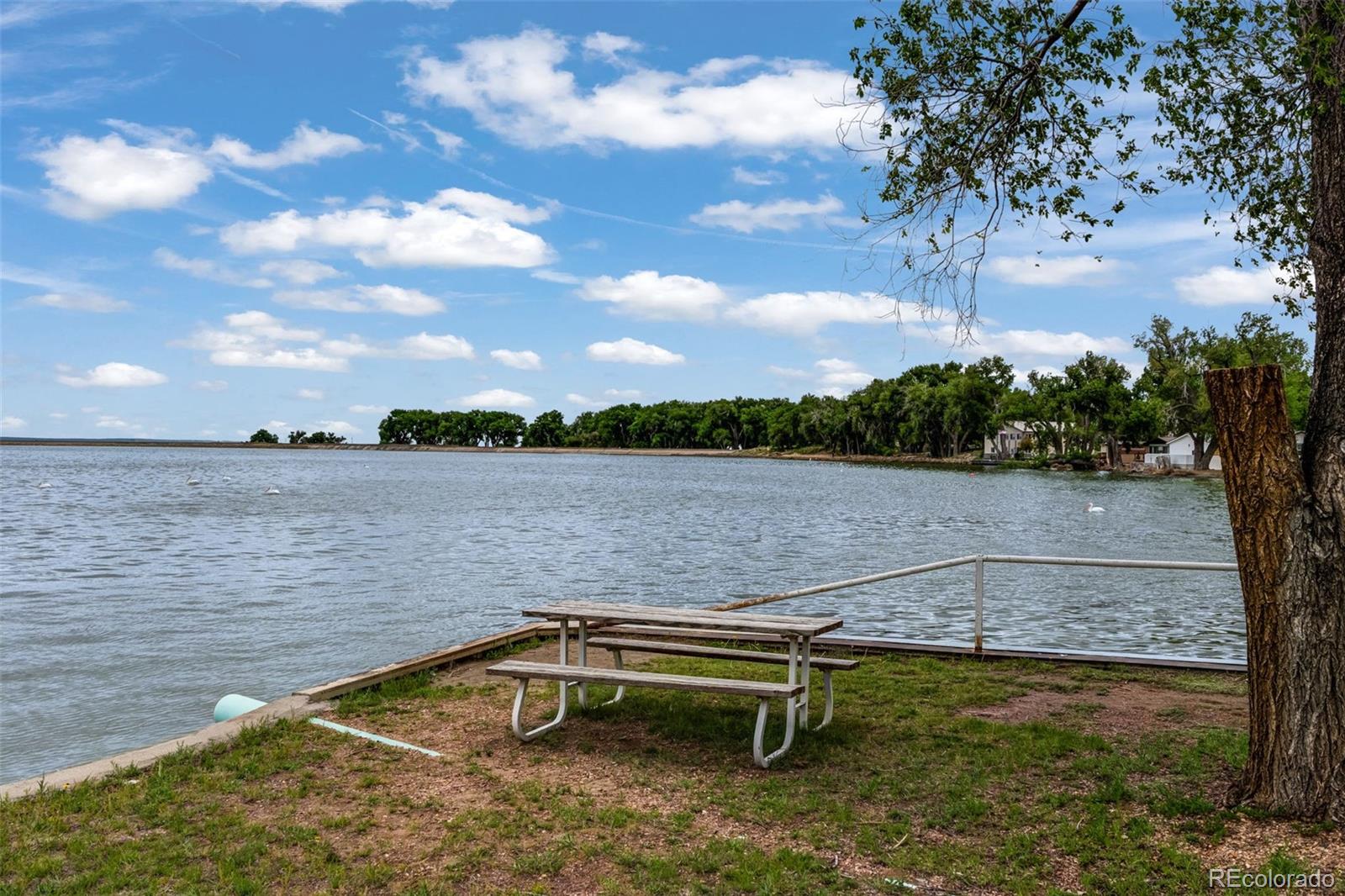 188 Kiowa Road Weldona, CO 80653 - Photo 24 of 34 a view of a lake with outdoor seating
