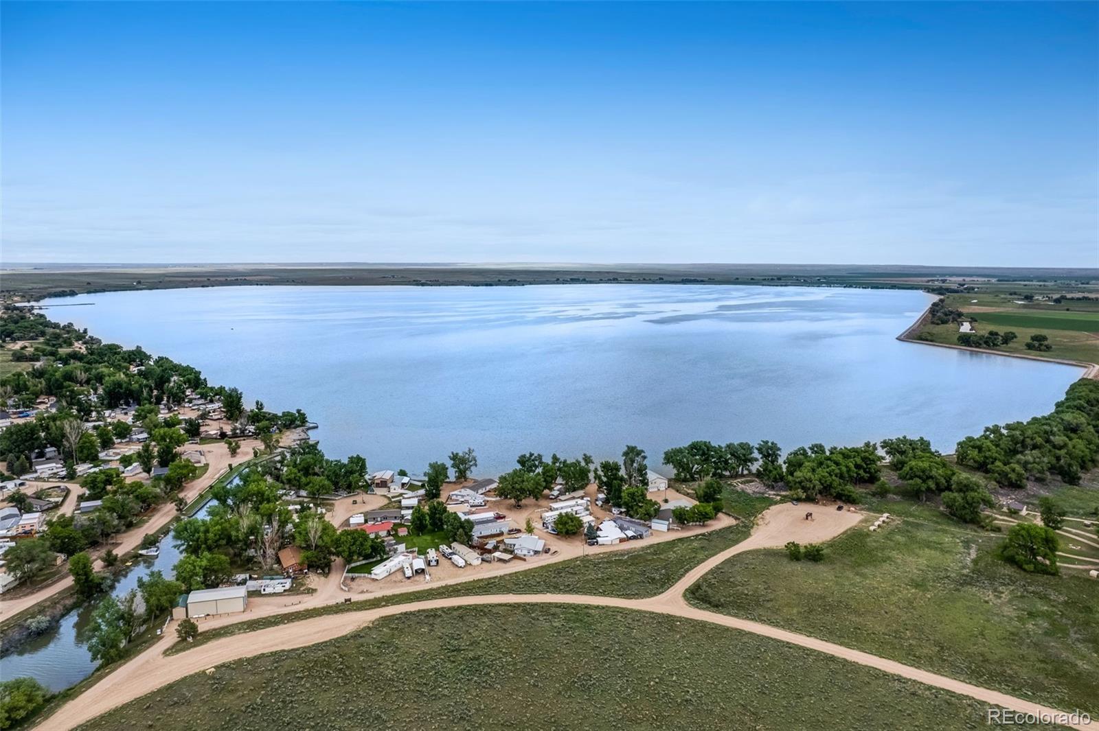 188 Kiowa Road Weldona, CO 80653 - Photo 34 of 34 an aerial view of a house with a yard and lake view