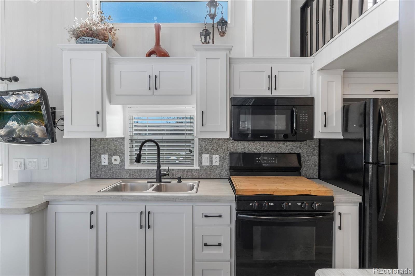 188 Kiowa Road Weldona, CO 80653 - Photo 5 of 34 a kitchen with a sink stove and cabinets