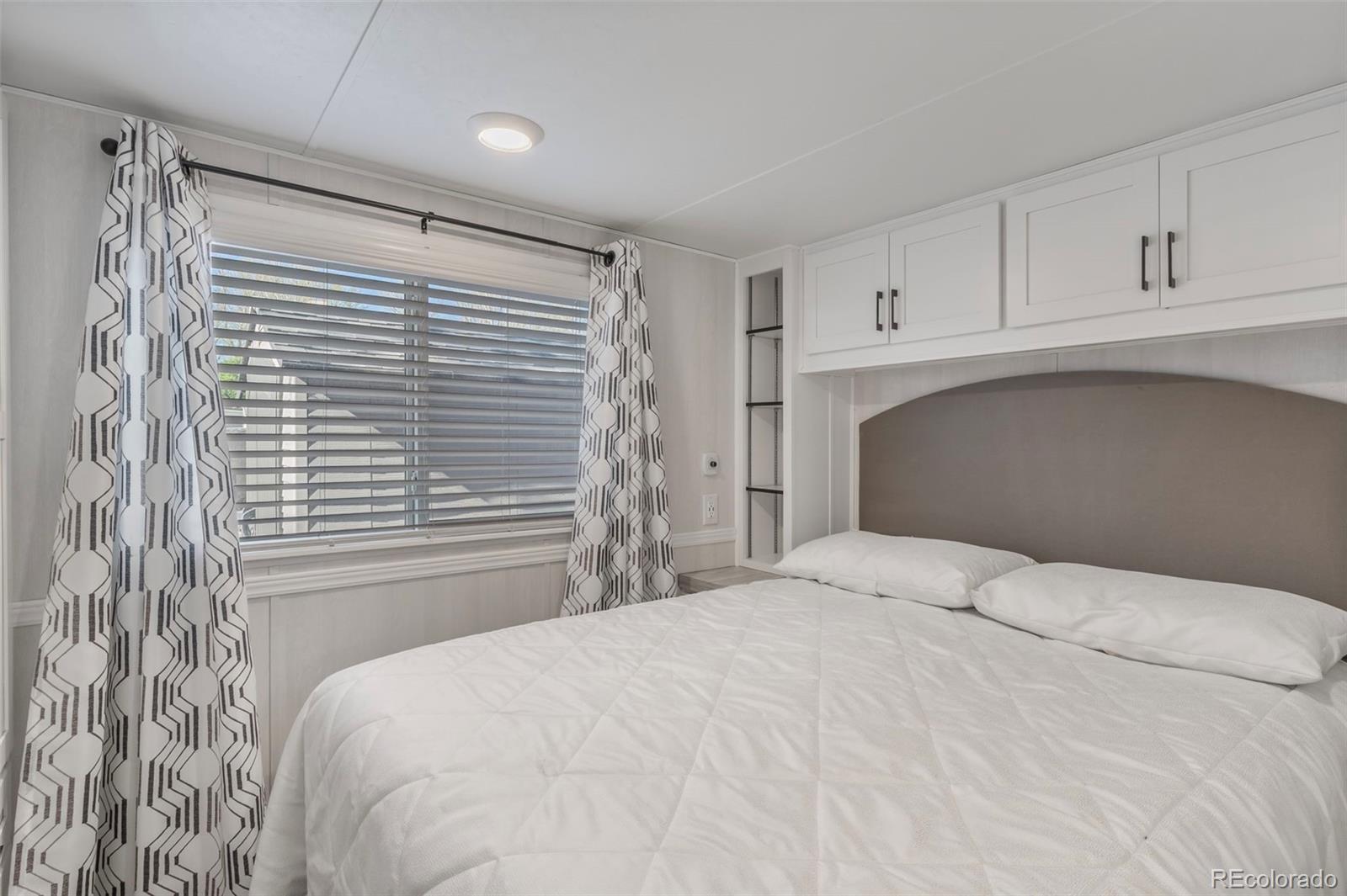 188 Kiowa Road Weldona, CO 80653 - Photo 7 of 34 a bedroom with a bed and a window