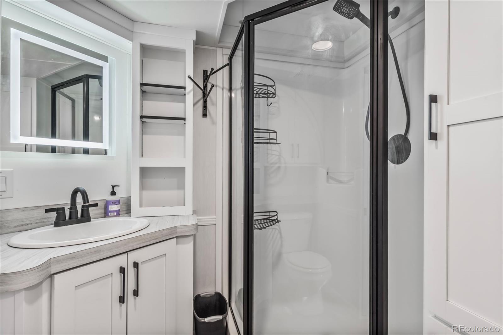 188 Kiowa Road Weldona, CO 80653 - Photo 8 of 34 a bathroom with a shower sink and mirror