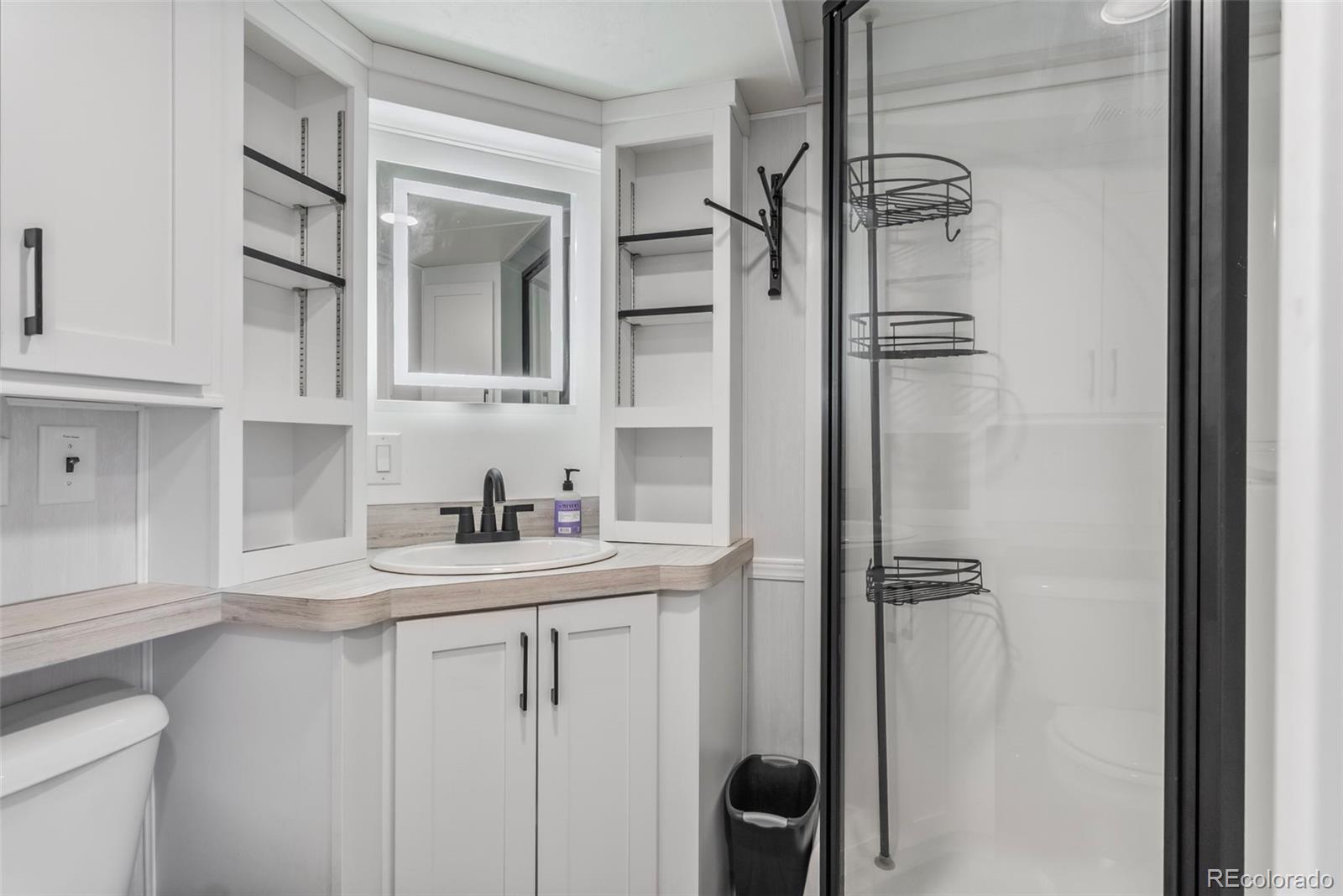 188 Kiowa Road Weldona, CO 80653 - Photo 9 of 34 a bathroom with a sink toilet and shower