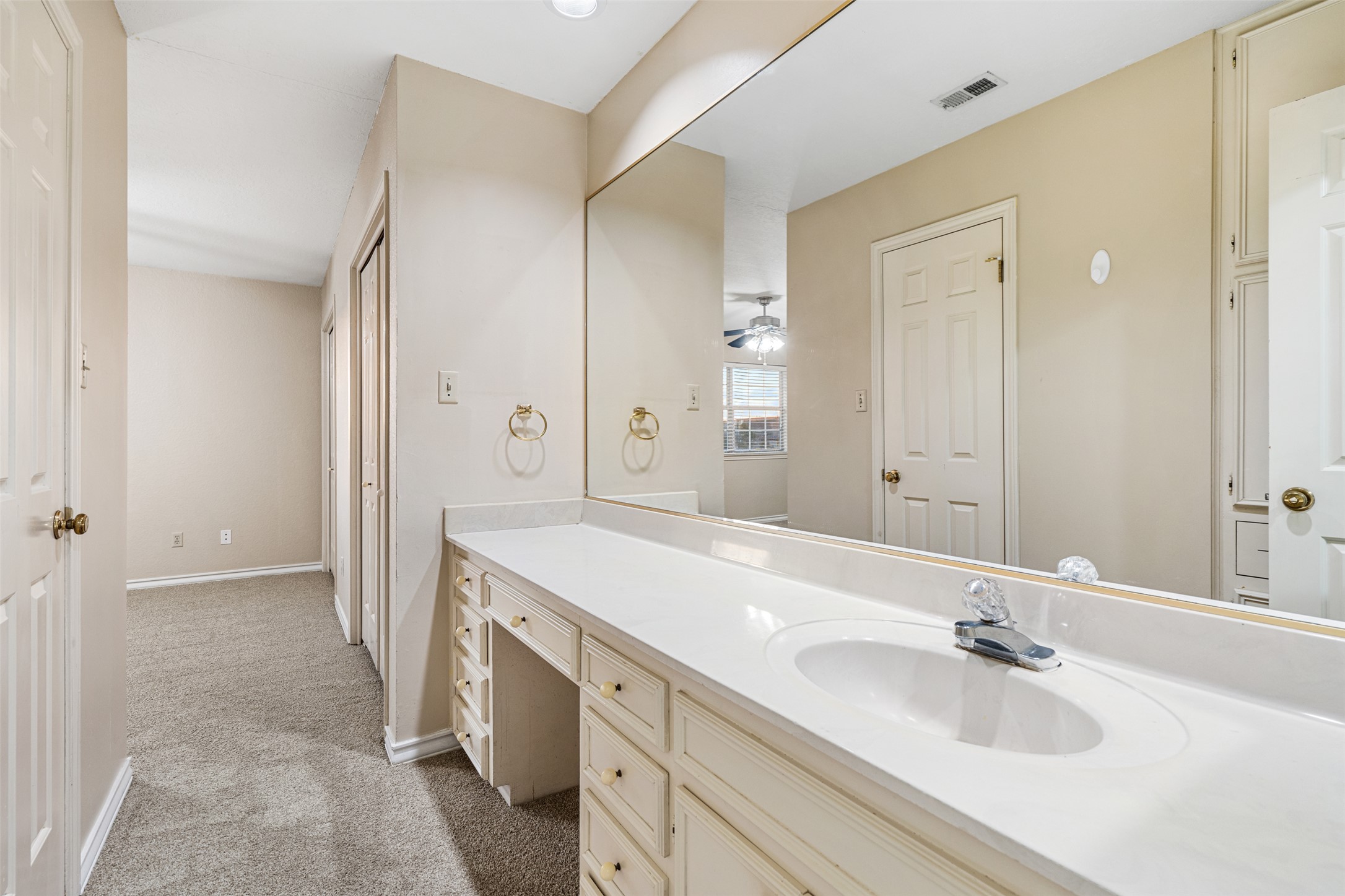 2408 Enfield Road, Unit 211 Austin, TX 78703 - Photo 19 of 26 Bathroom featuring light colored carpet, vanity, ceiling fan, and a closet