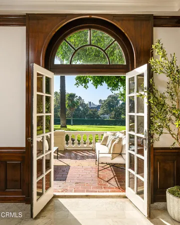 a view of a door and a living room